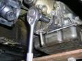 Removing cross member carrier bolts.